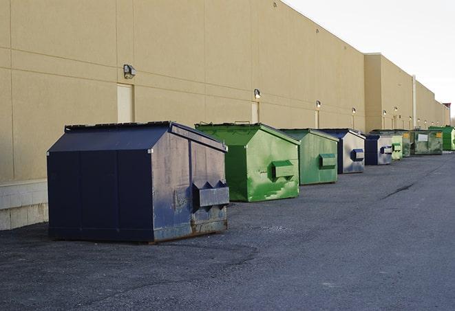 an overflowing dumpster filled with roofing shingles and other scraps from a construction project in Boynton Beach